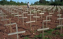 A young Rwandan girl walks through Nyaza cemetery outside Kigali, Rwanda, on Monday November 25, 1996, where thousands of victims of the 1994 genocide are buried (AP Photo/Ricardo Mazalan)