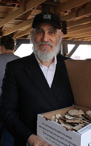 Pinchas Cohen, a restaurateur and father of nine from Brooklyn, brought his own box of handmade shmura matzah to the amusement park for Passover, April 25, 2016 (Uriel Heilman/via JTA) Pinchas Cohen, a restaurateur and father of nine from Brooklyn, brought his own box of handmade shmura matzah to the amusement park for Passover, April 25, 2016 (Uriel Heilman/via JTA)