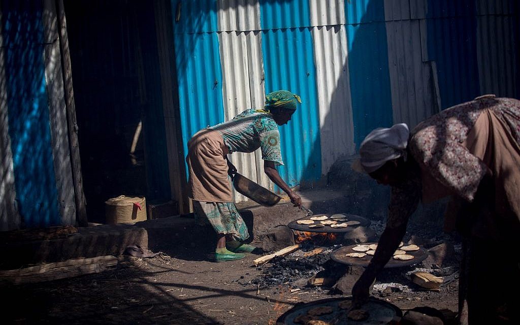 More than 20 Ethiopian Jewish women make matzah over fires in Gondar, Ethiopia on April 20, 2016. They receive a small salary at the end of the week. (Miriam Alster/Flash90)