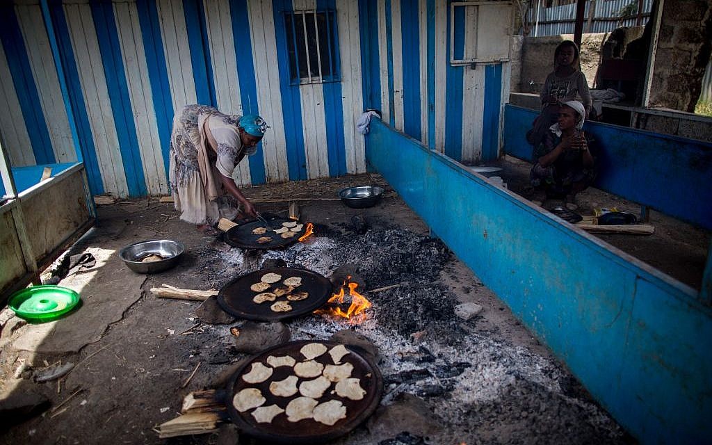 Women of Gondar's Jewish community prepare matzah before Passover on April 20, 2016. The matzah must stay on the fire for less than 10 minutes, so it is cooked in less than 18 minutes and is kosher for Passover. (Miriam Alster/Flash90)