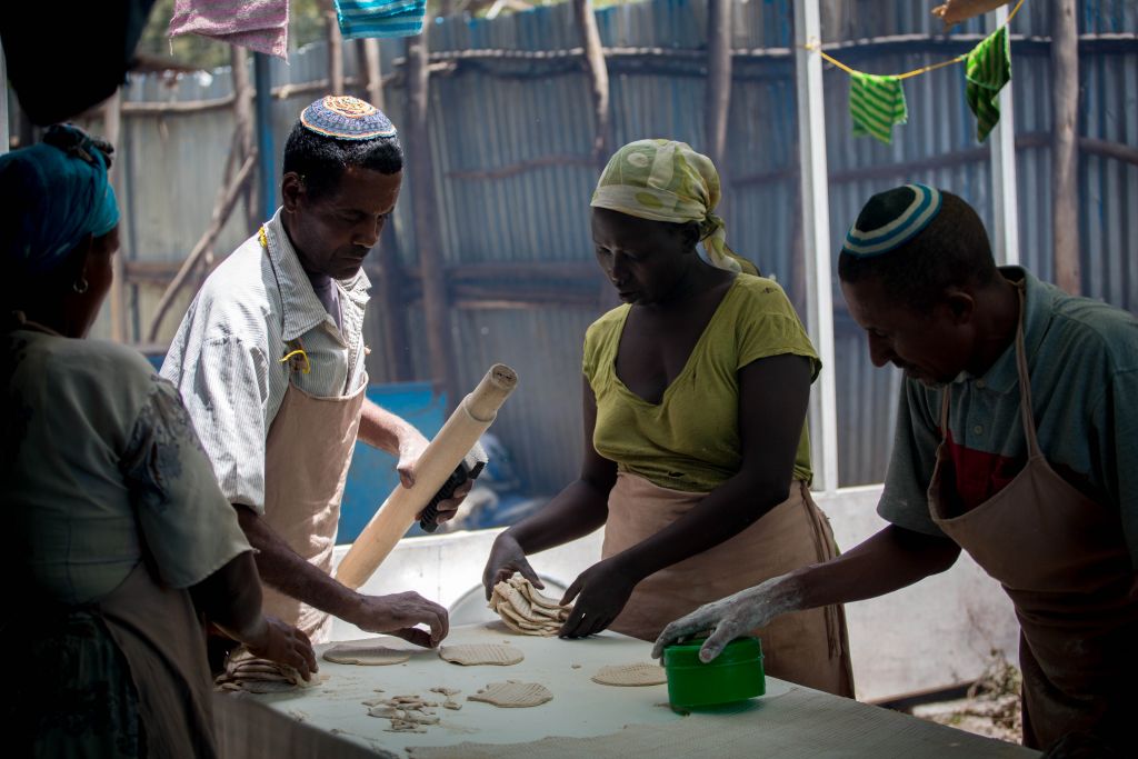Members of Gondar's Jewish community prepare matzah before Passover on April 20, 2016. Women collect cut matzah dough to bring to the stove. (Miriam Alster/Flash90) Members of Gondar's Jewish community prepare matzah before Passover on April 20, 2016. Women collect cut matzah dough to bring to the stove. (Miriam Alster/Flash90)