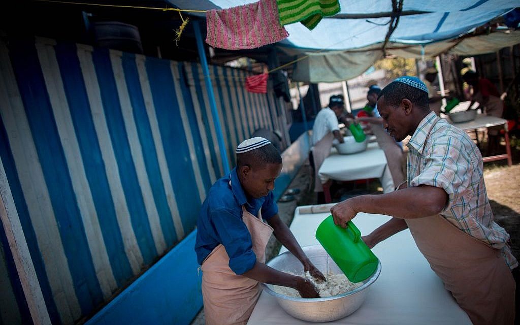 Members of Gondar's Jewish community prepare matzah before Passover on April 20, 2016. It takes more than 40 people a week to prepare the unleavened bread for the community. (Miriam Alster/Flash90)