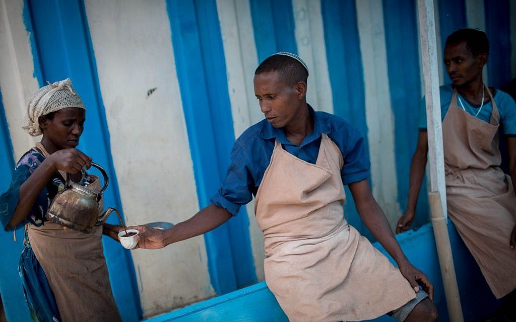 Members of Gondar's Jewish community take a coffee break from preparing matzah for 6,000 people before Passover on April 20, 2016. (Miriam Alster/Flash90)