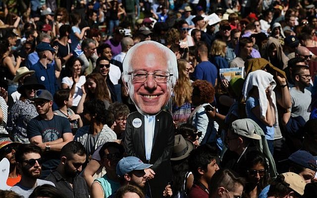 A supporter holds a cutout of Democratic presidential candidate Bernie Sanders during "A Future To Believe In GOTV" rally in Brooklyn, New York, April 17, 2016. (AFP PHOTO / TIMOTHY A. CLARY)