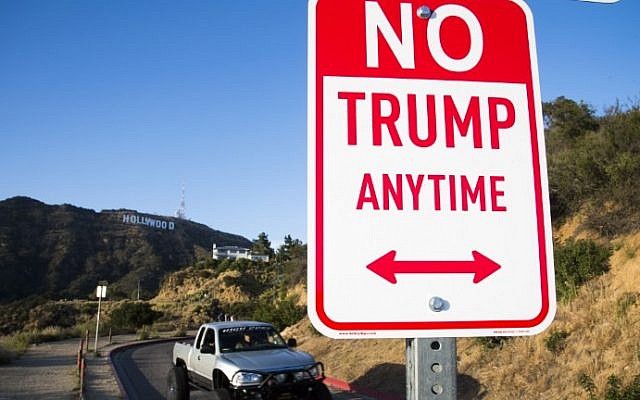 A sign reading 'No Trump Anytime' is seen near the iconic 'Hollywood' sign, April 27, 2016 in the hills above Hollywood, California. (AFP PHOTO / ROBYN BECK) A sign reading 'No Trump Anytime' is seen near the iconic 'Hollywood' sign, April 27, 2016 in the hills above Hollywood, California. (AFP PHOTO / ROBYN BECK)