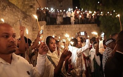 Ethiopian Christian pilgrims hold candles during an Ethiopian Orthodox ceremony of the "Holy Fire" at the Dir Al-Sultan Church held on the roof of the Holy Sepulcher in Jerusalem's Old City on April 30, 2016.(AFP PHOTO / MENAHEM KAHANA) Ethiopian Christian pilgrims hold candles during an Ethiopian Orthodox ceremony of the "Holy Fire" at the Dir Al-Sultan Church held on the roof of the Holy Sepulcher in Jerusalem's Old City on April 30, 2016.(AFP PHOTO / MENAHEM KAHANA)