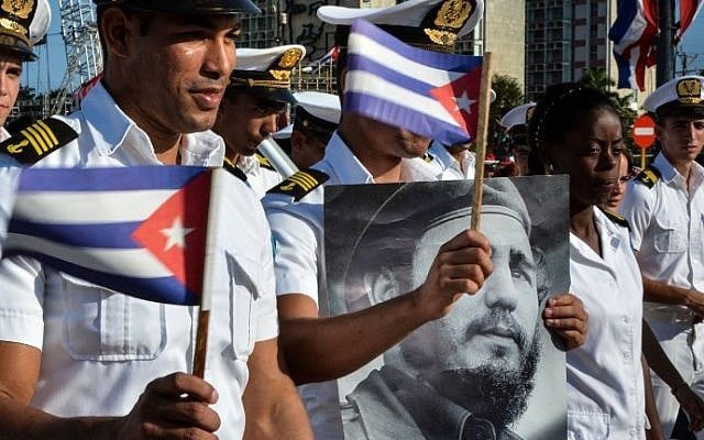 Members of the Navy display a picture of Cuban former president Fidel Castro during the May Day parade at Revolution Square in Havana, on May 1, 2016. (AFP PHOTO / JORGE BELTRAN)