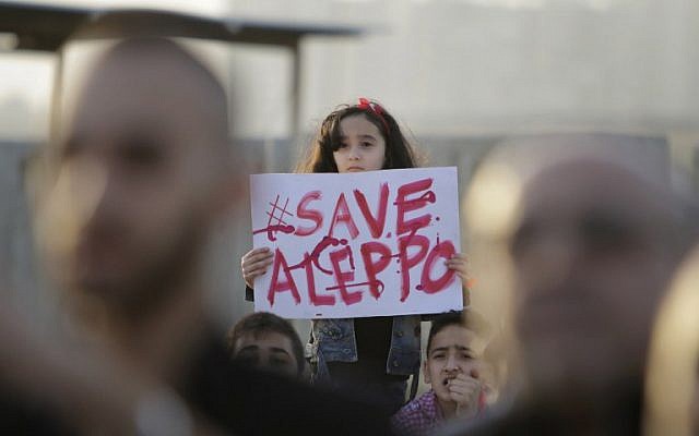 A Syrian girl holds a placard during a rally in solidarity with Aleppo, in the Lebanese northern port city of Tripoli, on May 1, 2016. (AFP/IBRAHIM CHALHOUB) A Syrian girl holds a placard during a rally in solidarity with Aleppo, in the Lebanese northern port city of Tripoli, on May 1, 2016. (AFP/IBRAHIM CHALHOUB)