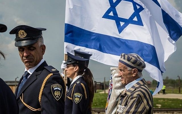 Holocaust survivor Edward Mossberg (R) and other participants of the annual "March of the Living" walk over the grounds of the former Auschwitz-Birkenau Nazi death camp in Brzezinka (Birkenau) near Oswiecim (Auschwitz), Poland, on May 5, 2016. (AFP Photo/Wojtek Radwanski)