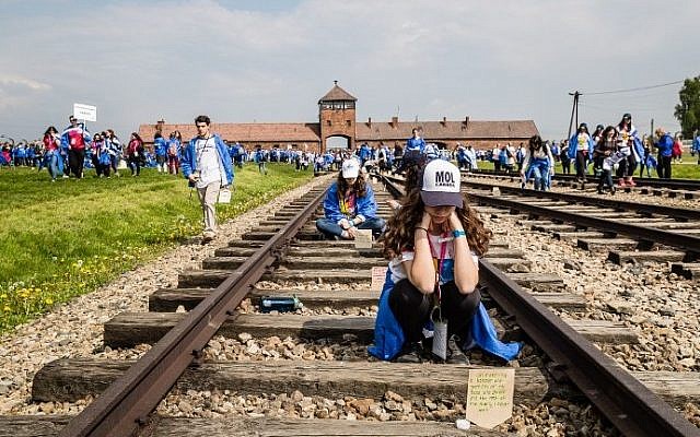 Participants of the annual March of the Living are seen on railtracks leading to the former Auschwitz-Birkenau Nazi death camp in Poland, on May 5, 2016. (AFP PHOTO / WOJTEK RADWANSKI)