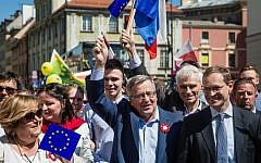 Former Polish President Bronislaw Komorowski (C), his wife Anna (L), Berlin Mayor Michael Mueller (R) and other participants march during the annual Schumann Parade to support the idea of a United Europe in Warsaw, Poland on May 7, 2016. (Wojtek Radwanski/AFP Photo/AFP)