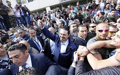 Lebanese former prime minister Saad Hariri (C), whose Future Movement usually dominates elections in the capital, takes a selfie as he leaves a polling station after voting for the municipal elections on May 8, 2016 in the capital Beirut. (AFP PHOTO / ANWAR AMRO)