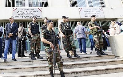 Lebanese security forces stand guard outside a polling station as people head to cast their votes for the municipal elections in the capital of Beirut, May 8, 2016. (AFP/Anwar Amro)