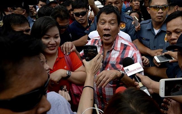 Presidential frontrunner and Davao City Mayor Rodrigo Duterte leaves the voting precint after casting his vote at Daniel Aguinaldo National High School in Davao City, on the southern island of Mindanao on May 9, 2016. (AFP PHOTO / NOEL CELIS) Presidential frontrunner and Davao City Mayor Rodrigo Duterte leaves the voting precint after casting his vote at Daniel Aguinaldo National High School in Davao City, on the southern island of Mindanao on May 9, 2016. (AFP PHOTO / NOEL CELIS)