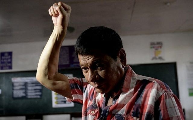 Presidential front-runner and Davao City Mayor Rodrigo Duterte gestures as he arrives at the voting precinct to cast his vote at Daniel Aguinaldo National High School in Davao City, on the southern island of Mindanao on May 9, 2016. (AFP/Noel Celis) Presidential front-runner and Davao City Mayor Rodrigo Duterte gestures as he arrives at the voting precinct to cast his vote at Daniel Aguinaldo National High School in Davao City, on the southern island of Mindanao on May 9, 2016. (AFP/Noel Celis)