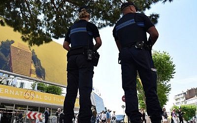French police officers stand guard outside the Palais des Festivals in the southeastern French city of Cannes on May 10, 2016 on the eve of the opening ceremony of the 69th Cannes Film Festival. AFP/ ALBERTO PIZZOLI)