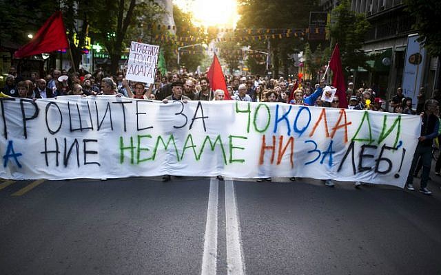 Protesters walk behind a banner reading "You spend for chocolate, while we don't even have enough for bread," in Skopje, Macedonia on May 10, 2016. (Robert Atanasovski/AFP) Protesters walk behind a banner reading "You spend for chocolate, while we don't even have enough for bread," in Skopje, Macedonia on May 10, 2016. (Robert Atanasovski/AFP)