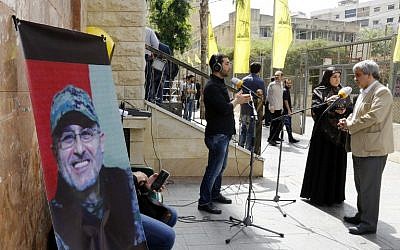 Lebanese press report from outside where family members are receiving condolences for the death of top Hezbollah commander Mustafa Badreddine who was killed in an attack in Syria in a southern suburb of Beirut on May 13, 2016. (AFP PHOTO / ANWAR AMRO)