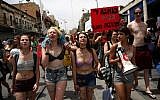 Israeli activists chant slogans, as they carry placards, during the 5th annual 'SlutWalk' march through central Jerusalem on May 13, 2016 (AFP PHOTO / GALI TIBBON)