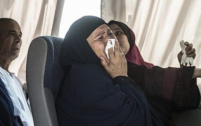 A relative of a passenger who was flying aboard an EgyptAir plane that vanished from radar en route from Paris to Cairo overnight cries as family members are transported by bus to a gathering point at Cairo airport on May 19, 2016. (AFP PHOTO / KHALED DESOUKI)