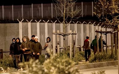 Migrants walk out of the 'Jungle' in Calais on May 20, 2016, to reach the circular road where they can block passing trucks in order to get inside and travel to Great Britain. (AFP PHOTO/PHILIPPE HUGUEN) Migrants walk out of the 'Jungle' in Calais on May 20, 2016, to reach the circular road where they can block passing trucks in order to get inside and travel to Great Britain. (AFP PHOTO/PHILIPPE HUGUEN)