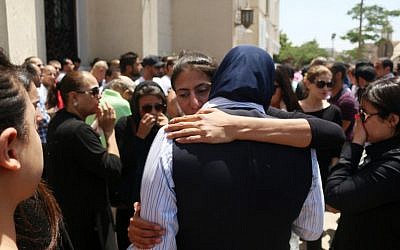 Relatives and friends of passengers of the EgyptAir plane that crashed in the Mediterranean, comfort each other on May 20, 2016 during prayers at Abou Bakr el-Sedek mosque in Cairo. (AFP PHOTO/MOHAMED METEAB)