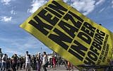 Supporters of Austrian presidential candidate Alexander Van der Bellen dance behind a sign reading 'No Nazi at the Hofburg' during a rave outside of Hofburg palace on the eve of elections in Vienna, Austria, May 21, 2016. (AFP/Joe Klamar)