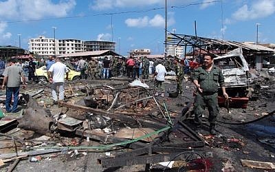 In this May 23, 2016 image, Syrians gather at the site of multiple bombings that left tens dead in the northern coastal city of Jableh, between Latakia and Tartus. (AFP Photo/Stringer)