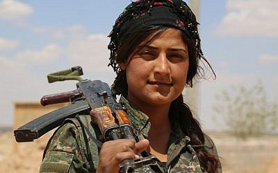 A fighter from the Kurdish People's Protection Units (YPG), part of the Syrian Democratic Forces (SDF), holds her weapon in the village of Fatisah in the northern Syrian province of Raqa on May 25, 2016. (AFP PHOTO / DELIL SOULEIMAN) A fighter from the Kurdish People's Protection Units (YPG), part of the Syrian Democratic Forces (SDF), holds her weapon in the village of Fatisah in the northern Syrian province of Raqa on May 25, 2016. (AFP PHOTO / DELIL SOULEIMAN)