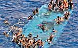 In this photo taken in the Mediterranean Sea, off the Libyan coast, May 27, 2016, rescuers tow migrants to the Italian Navy ship Vega, after the boat they were aboard sunk. (Raffaele Martino/Marina Militare via AP)