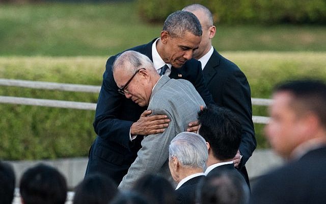 US President Barack Obama hugs a survivor of the atomic bombing of Hiroshima at the Hiroshima Peace Memorial park cenotaph in Hiroshima on May 27, 2016. (AFP Photo/Johannes Eisele)