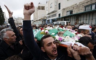 Relatives and friends chant slogans against Israel during the funeral in Hebron on May 28, 2016, of Abdel Fattah al-Sharif, a wounded Palestinian assailant who was shot dead by an Israeli soldier after lying wounded on the ground in the city of Hebron on March 24, 2016. (AFP/Hazem Bader)