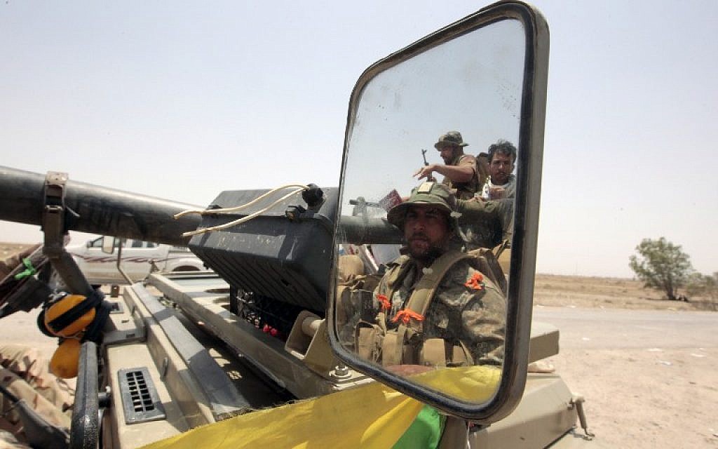 Iraqi pro-government forces drive in an area between the village of al-Sejar and Fallujah, on May 28, 2016, as they take part in a major assault to retake the city of Fallujah, from the Islamic State (IS) group.(AFP PHOTO / SABAH ARAR)