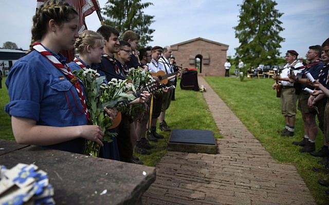 German youths play music on May 28, 2016 at the German WWI cemetery in Romagne-sous-Montfaucon, eastern France, during the burial of Hans Winckelmann, a WWI German soldier, as part of the 100-year commemoration of WWI's Battle of Verdun. (AFP/JEAN-CHRISTOPHE VERHAEGEN)