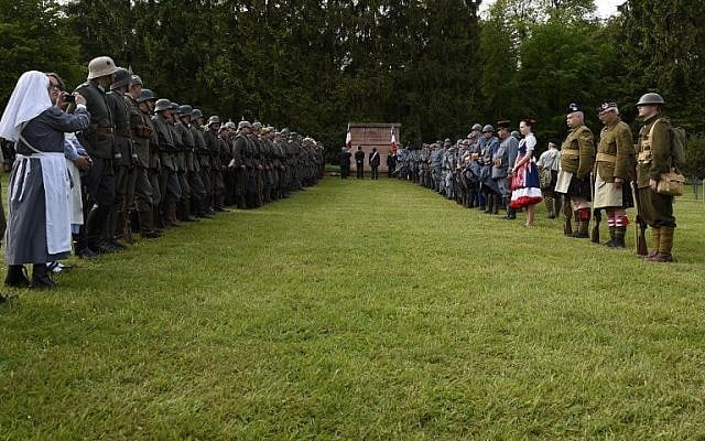 Reenactors dressed as French and German soldiers take part in a ceremony at the German World War I cemetery of Troyon, eastern France, on May 28, 2016, as part of the 100-year commemoration of WWI's Battle of Verdun. (AFP/Jean-Christophe Verhaegen) Reenactors dressed as French and German soldiers take part in a ceremony at the German World War I cemetery of Troyon, eastern France, on May 28, 2016, as part of the 100-year commemoration of WWI's Battle of Verdun. (AFP/Jean-Christophe Verhaegen)