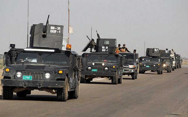 Iraq's counter-terrorism service (CTS) reach al-Sejar village in Iraq's Anbar province, on the boundaries of Fallujah, as they take part in a major assault to retake the city from the Islamic State (IS) group, May 28, 2016. (AFP/AHMAD AL-RUBAYE)