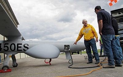 North Dakota State University agricultural researcher John Nowatzki points to a mechanical panel of a Hermes 450 drone before the aircraft took off from the Hillsboro, N.D. airport on May 20, 2016, to collect agriculture data. (AP Photo/Dave Kolpack)