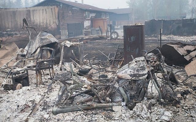 Home foundations and skeletons of possesions are all that remain in parts of a residential neighborhood destroyed by a wildfire on May 7, 2016 in Fort McMurray, Canada.(Scott Olson/Getty Images/AFP) Home foundations and skeletons of possesions are all that remain in parts of a residential neighborhood destroyed by a wildfire on May 7, 2016 in Fort McMurray, Canada.(Scott Olson/Getty Images/AFP)