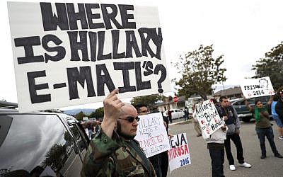 Protestors hold signs outside of a campaign rally for Hillary Clinton at Harrell College on May 25, 2016 in Riverside, California. Justin Sullivan/Getty Images/AFP) Protestors hold signs outside of a campaign rally for Hillary Clinton at Harrell College on May 25, 2016 in Riverside, California. Justin Sullivan/Getty Images/AFP)