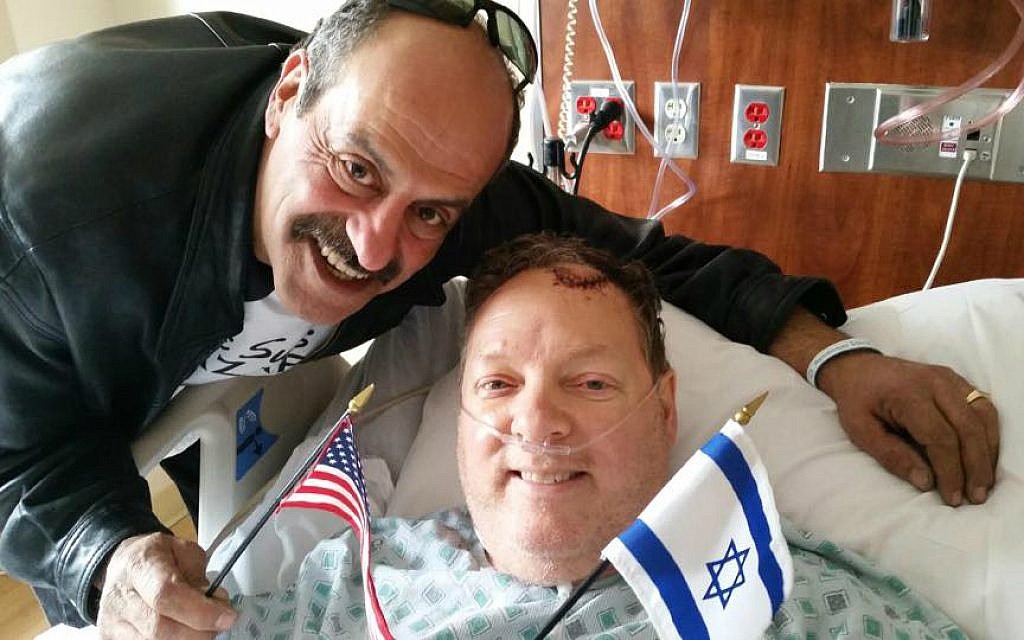 Hany Baransi (left) visits Bill Foley in hospital. Foley was seriously injured in a machete attack on Baransi's restaurant in Columbus, Ohio on February 11, 2016. (Courtesy) Hany Baransi (left) visits Bill Foley in hospital. Foley was seriously injured in a machete attack on Baransi's restaurant in Columbus, Ohio on February 11, 2016. (Courtesy)