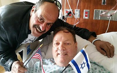 Hany Baransi (left) visits Bill Foley in hospital. Foley was seriously injured in a machete attack on Baransi's restaurant in Columbus, Ohio on February 11, 2016. (Courtesy)