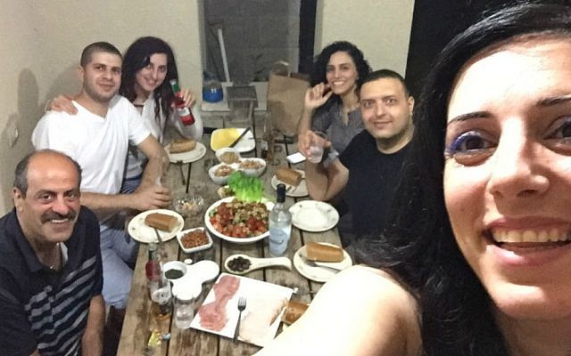 Hany Baransi (left) smiles for a selfie with relatives during his visit home to Israel in May 2016. (Courtesy)