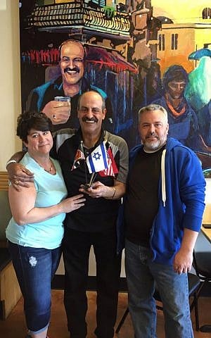 Hany Baransi (center) poses at his Nazareth Restaurant in Columbus, Ohio with a couple who recovered from injuries sustained in a machete attack at the restaurant on February 11, 2016. (Courtesy)