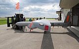 An Israeli-built Elbit Systems Hermes 450 unmanned aircraft is towed out of a hangar at the Hillsboro, North Dakota airport, where it was being used to collect agricultural data, May 20, 2016. (AP Photo/Dave Kolpack)