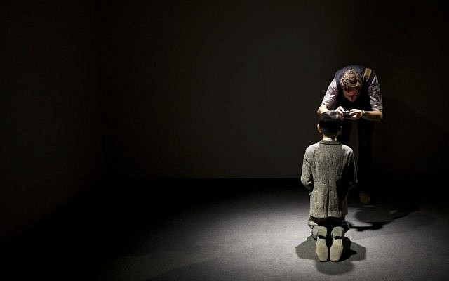 In this Friday, April 29, 2016 photo, a visitor takes a photo of 'Him' by Maurizio Cattelan on display during the press preview of 'Bound to Fail' at Christie's auction house in New York. (AP/Mary Altaffer)