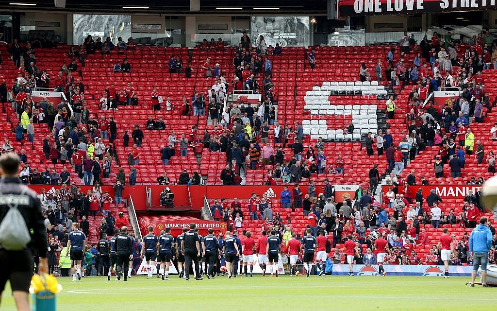 Fans leave the stands after an English Premier League match at Old Trafford, Manchester, England was called off Sunday May 15, 2016 over a security threat (Martin Rickett/PA via AP)