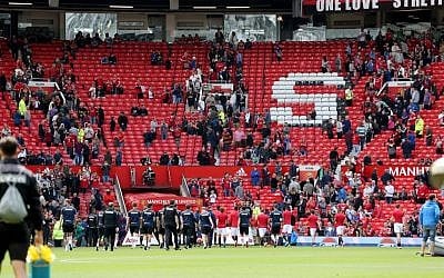 Fans leave the stands after an English Premier League match at Old Trafford, Manchester, England was called off Sunday May 15, 2016 over a security threat (Martin Rickett/PA via AP)