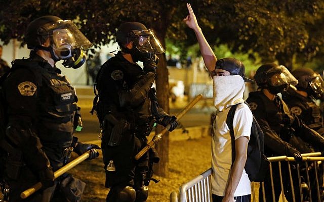Riot police block off the Albuquerque Convention Center to anti-Trump protests following a rally and speech by Republican presidential candidate Donald Trump at the convention center, May 24, 2016. (AP Photo/Brennan Linsley)