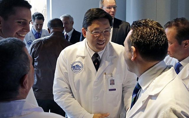 Dr. Dicken Ko, director of Massachusetts General Hospital's urology program, shakes hands with surgical team members after a news conference at the hospital, May 16, 2016. (AP Photo/Elise Amendola) Dr. Dicken Ko, director of Massachusetts General Hospital's urology program, shakes hands with surgical team members after a news conference at the hospital, May 16, 2016. (AP Photo/Elise Amendola)