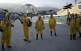 In this Tuesday, Jan. 26, 2016 file photo, health workers get ready to spray insecticide to combat the Aedes aegypti mosquitoes that transmits the Zika virus, under the bleachers of the Sambadrome in Rio de Janeiro, used for the Archery competition in the 2016 summer games. (AP/Leo Correa, File)